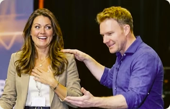 Richard coaching a speaker on stage