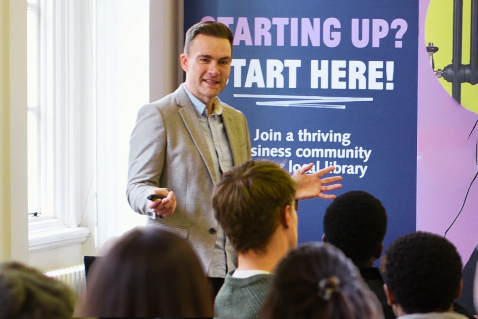 Richard speaking to a workshop audience in front of a Starting Up banner